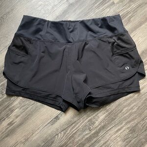 Black athletic shorts, size medium.